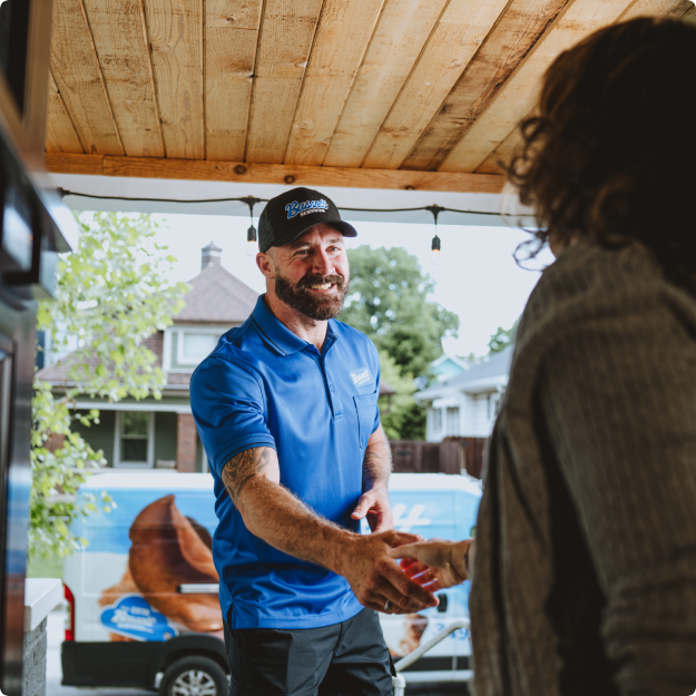 Bassett Services technician shaking hands with homeowner
