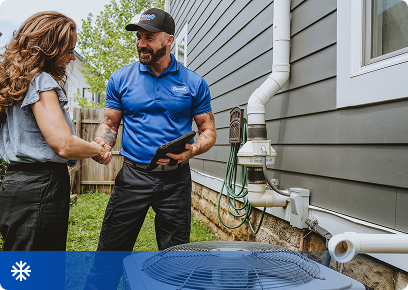 Cooling CTA Bassett Services technician talking with a homeowner beside her outdoor AC unit