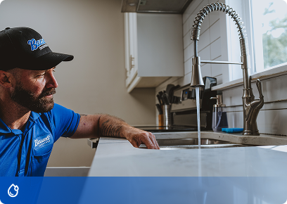 Bassett-Plumbing-CTA Bassett Services plumber checking a kitchen sink faucet